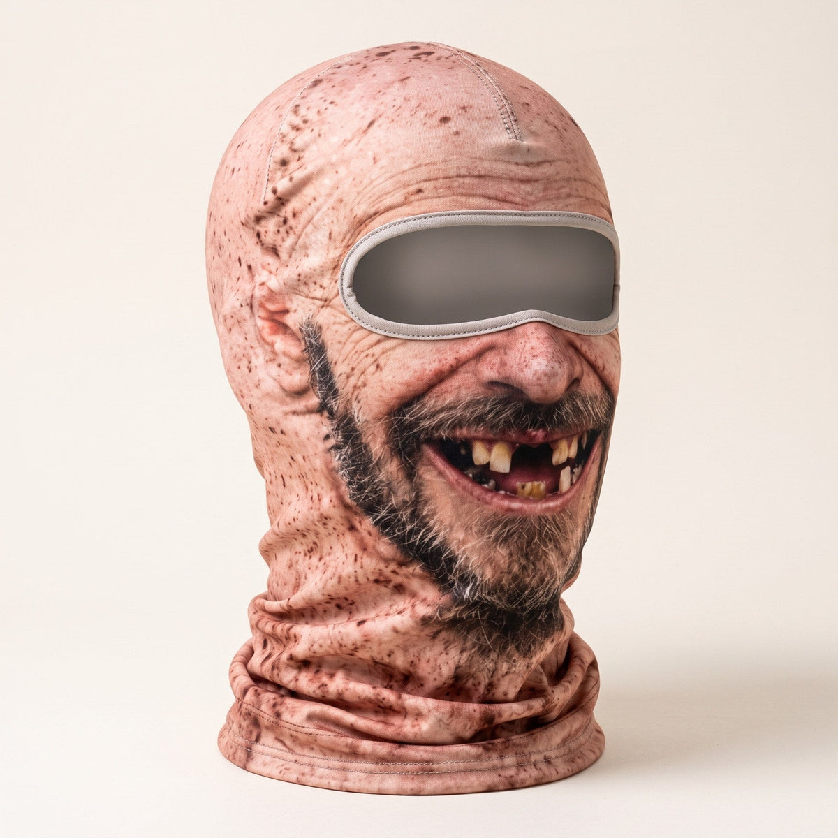 Illustrative product photo: Three-quarter studio view of Style C printed grin balaclava showing eye-opening binding and center seam. Focal point: 50% 50%.